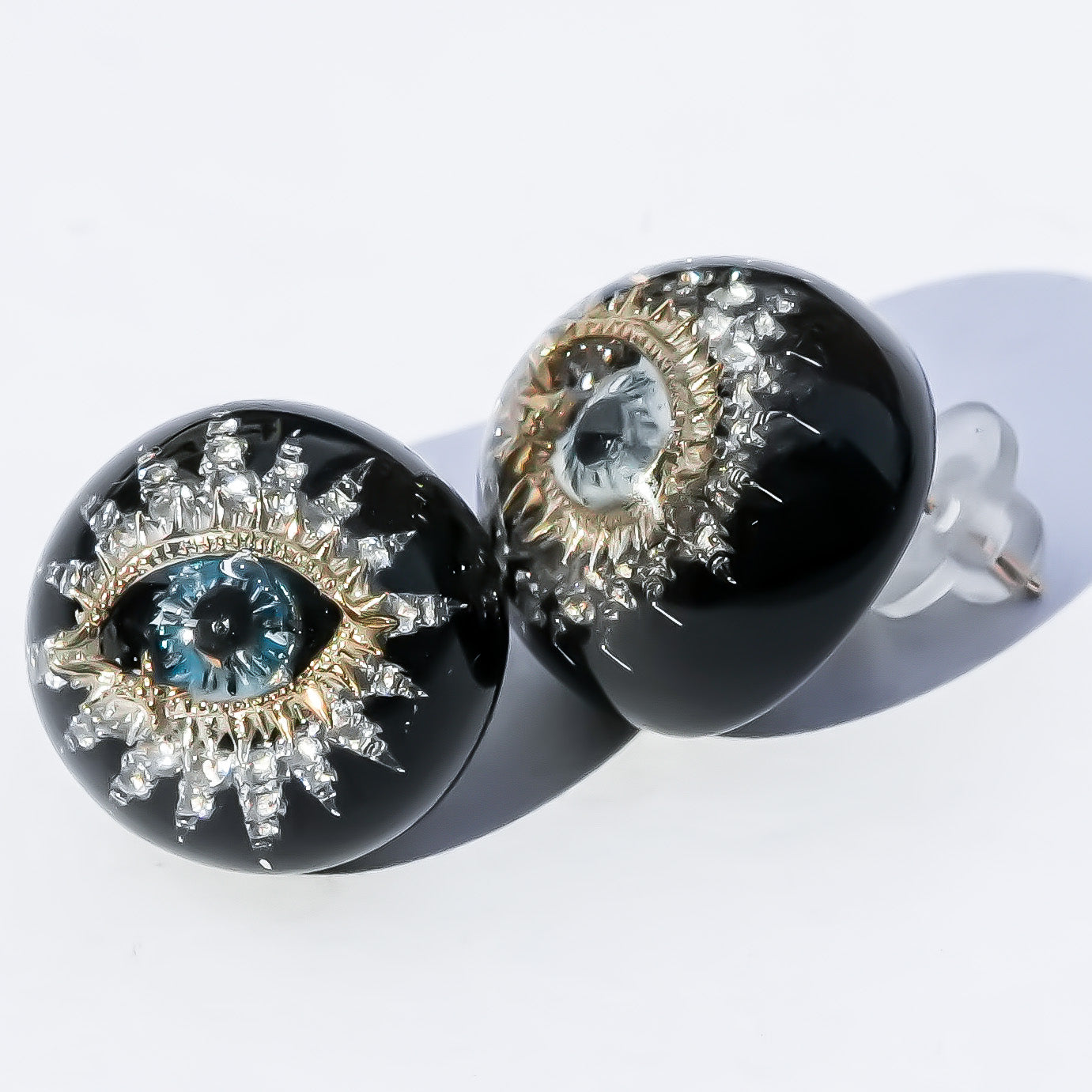 Guardian starburst eye earrings - black × gold