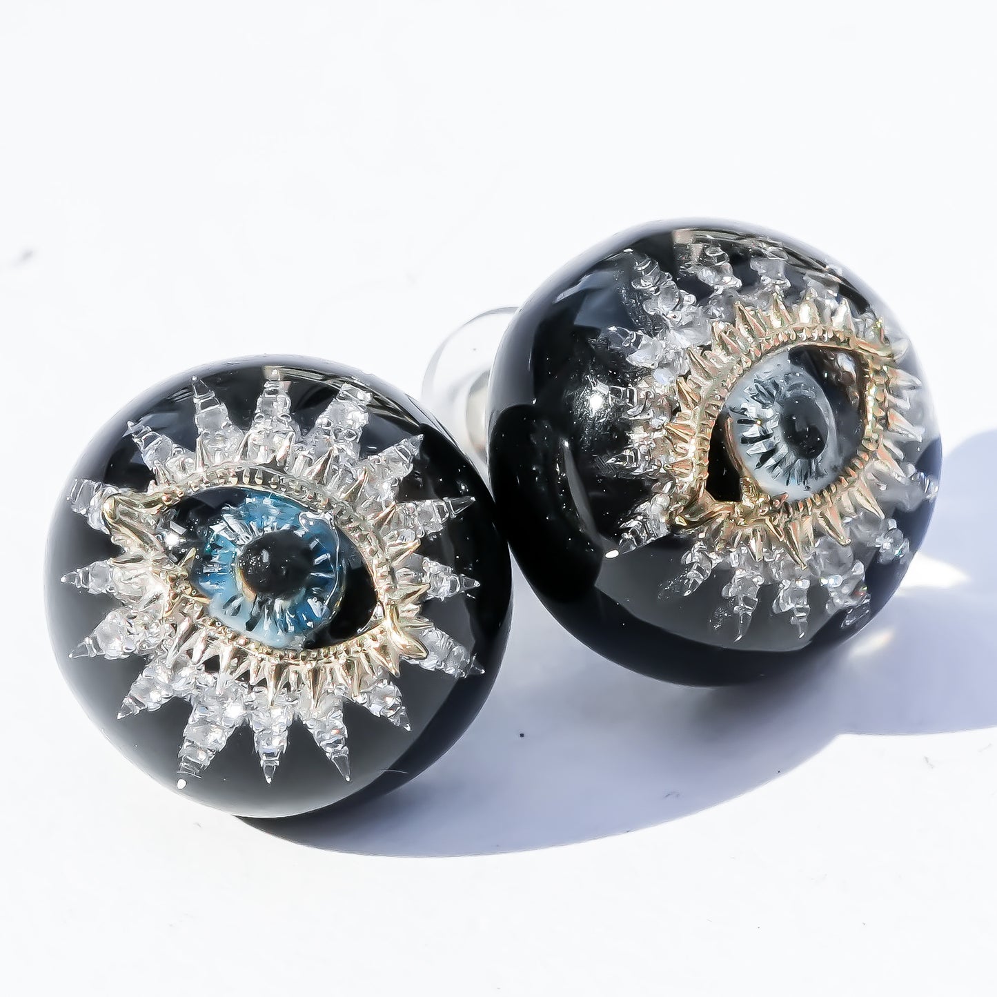 Guardian starburst eye earrings - black × gold