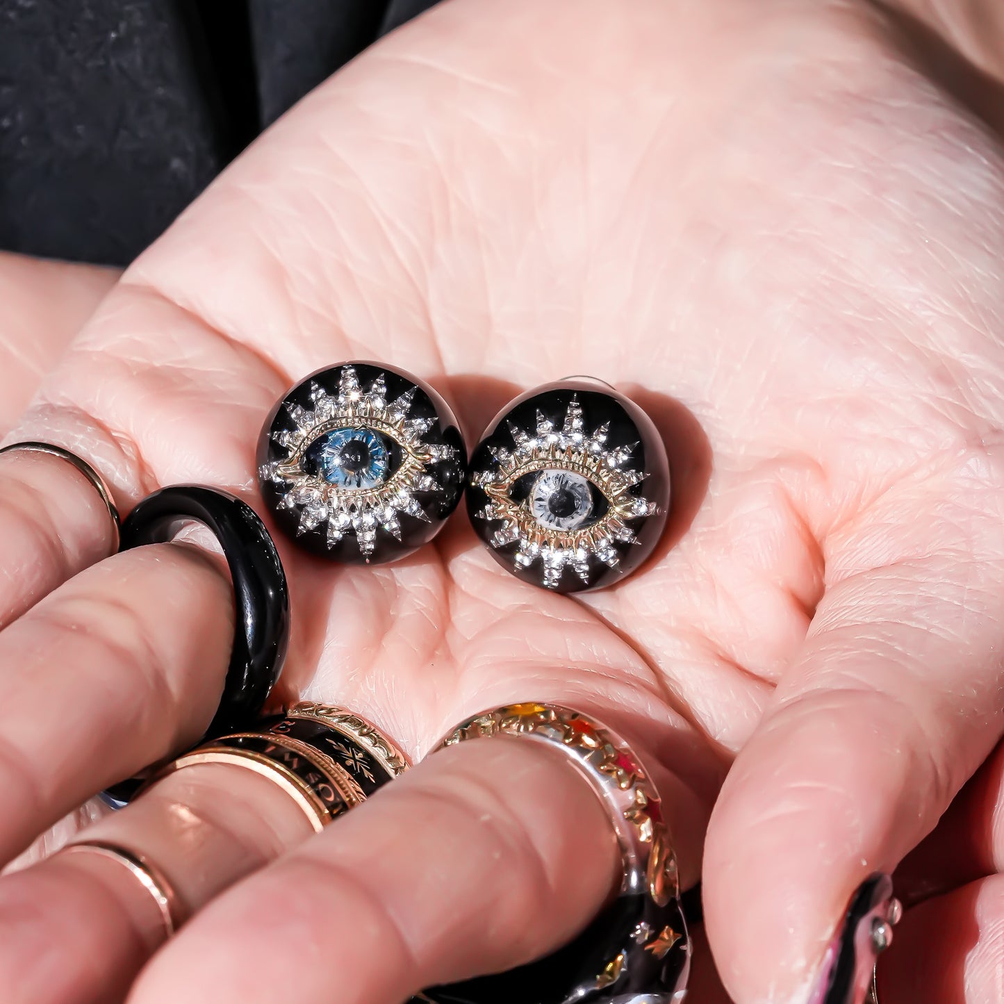 Guardian starburst eye earrings - black × gold