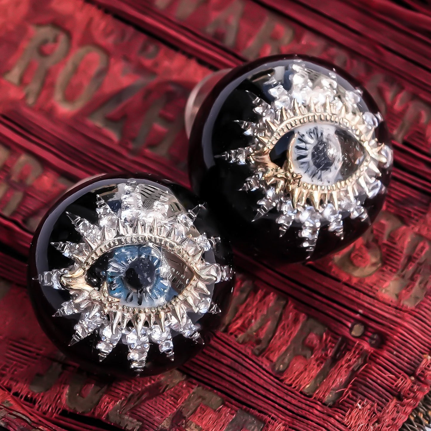 Guardian starburst eye earrings - black × gold